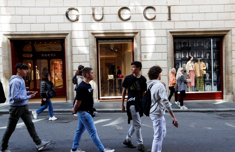 FILE PHOTO: People walk outside a Gucci shop in Rome, April 20, 2023. REUTERS/Remo Casilli/File Photo