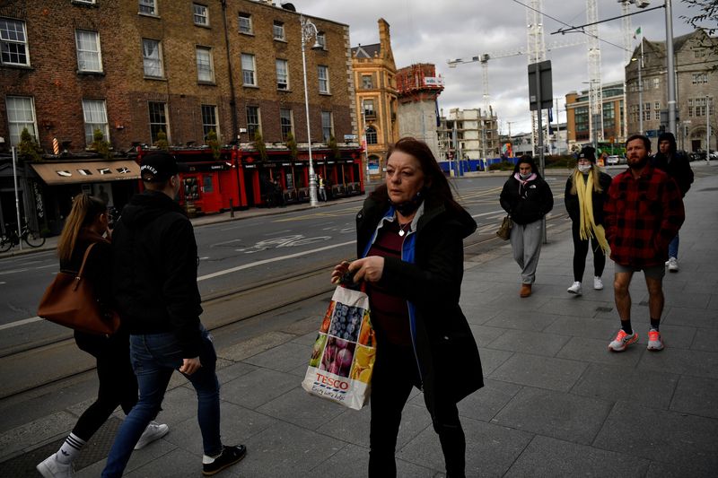 People walk along a street in the city centre of Dublin, Ireland, February 11, 2022. REUTERS/Clodagh Kilcoyne/ File Photo