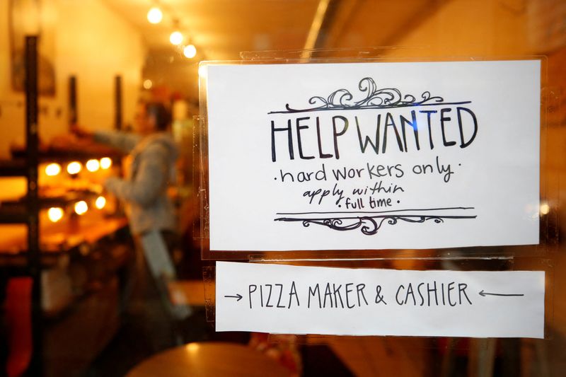FILE PHOTO: A "Help wanted" sign is seen in the window of a bakery in Ottawa, Ontario, Canada, November 2, 2017. REUTERS/Chris Wattie/File Photo