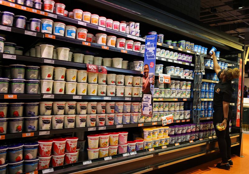 A shopper picks an item at the dairy section as she shops in Sandton, South Africa, September 22, 2025. REUTERS/Siphiwe Sibeko