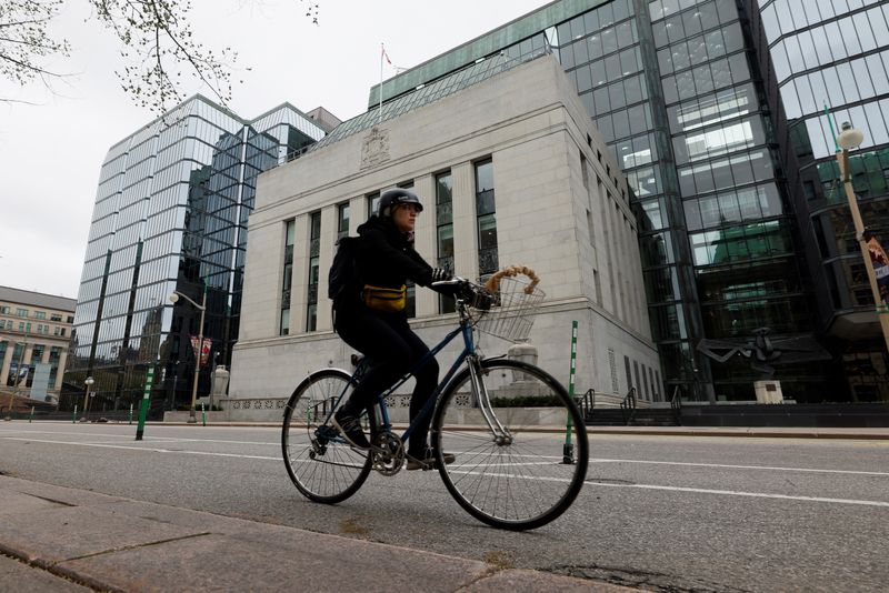 A cyclist rides past the Bank of Canada building in Ottawa, Ontario, Canada May 8, 2025. REUTERS/Blair Gable