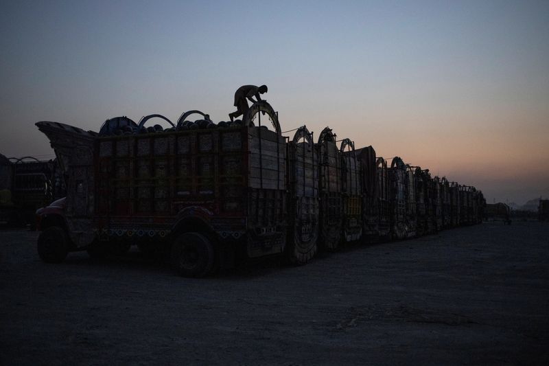A man stands on a truck packed with watermelons for auction at the Sabzi and Ghalla Mandi (Fruit and Vegetable Market) in Islamabad, Pakistan, May 17, 2025. REUTERS/Adrees Latif