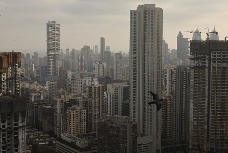 A bird flies past high rise buildings in Mumbai, India, May 5, 2025. REUTERS/Francis Mascarenhas