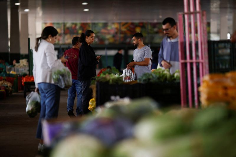 People are seen buying from a supply centre (CEASA) in Brasilia, Brazil May 9, 2023. REUTERS/Adriano Machado