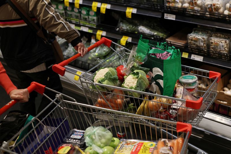 Shoppers push trolleys full of produce at a Coles supermarket in Bondi Junction, ahead of Coles Group announcing their first-quarter sales results, in Sydney, Australia, October 29, 2025. REUTERS/Hollie Adams