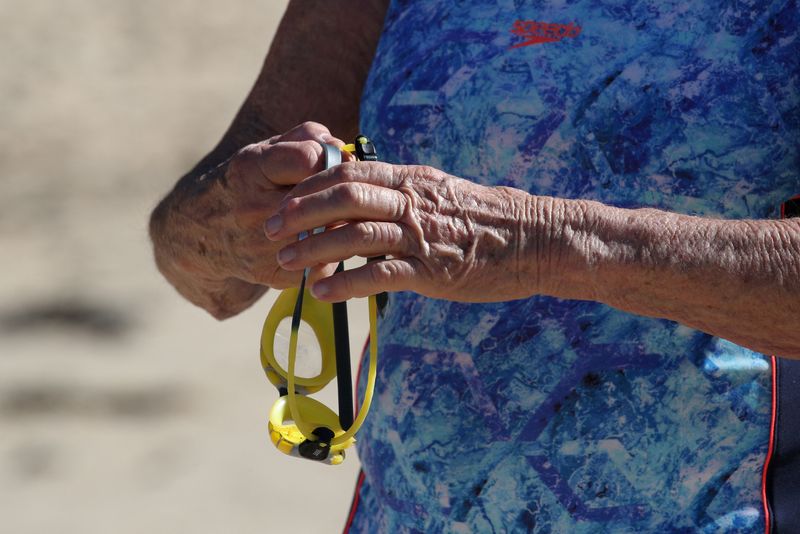 FILE PHOTO: An elderly swimmer prepares to get into the water at Clovelly Beach in Sydney, Australia, May 6, 2020. REUTERS/Loren Elliott/File Photo