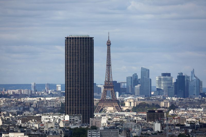 A general view shows the Montparnasse Tower and the Eiffel Tower with the financial and business district of La Defense in the background, in Paris, France, August 22, 2025. REUTERS/Abdul Saboor