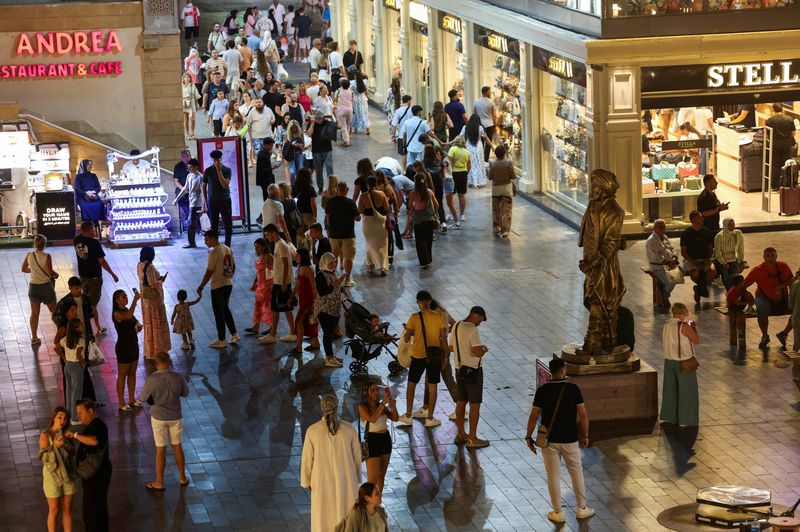 Tourists walk at a popular tourist area named "Old Market" in the Red Sea resort of Sharm el-Sheikh, Egypt, October 14, 2025. REUTERS/Mohamed Abd El Ghany