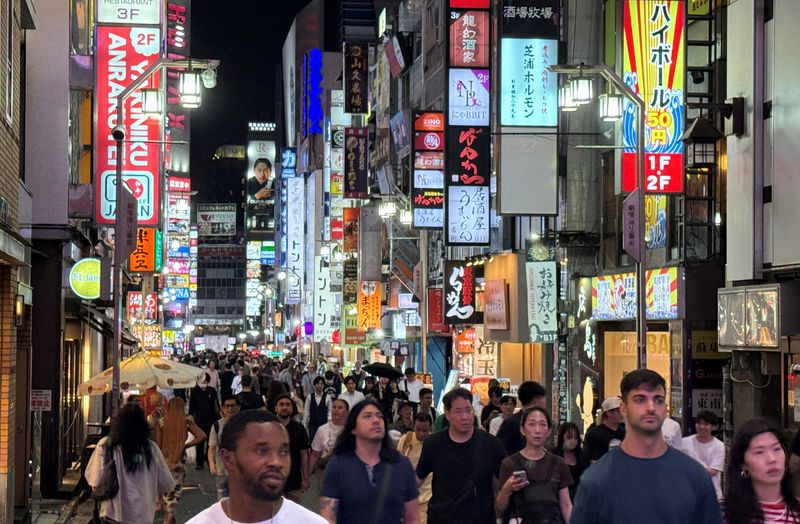 FILE PHOTO: People walk at a shopping area of Shinjuku in Tokyo, Japan, September 11, 2025.     REUTERS/Fabrizio Bensch/File Photo