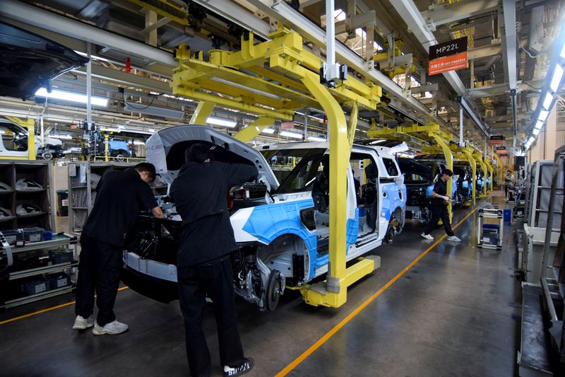 FILE PHOTO: Workers build Zeekr 009 electric minivans at Zeekr's factory in Ningbo, China, April 20, 2025. REUTERS/Nick Carey/File Photo