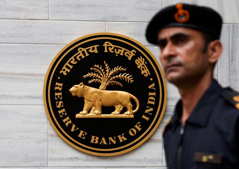 FILE PHOTO: A man walks past the Reserve Bank of India (RBI) logo outside its headquarters in Mumbai, India, June 6, 2025. REUTERS/Francis Mascarenhas/File Photo