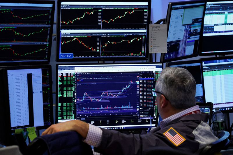 FILE PHOTO: A trader works on the floor at the New York Stock Exchange (NYSE) in New York City, U.S., November 10, 2025.  REUTERS/Brendan McDermid/File Photo