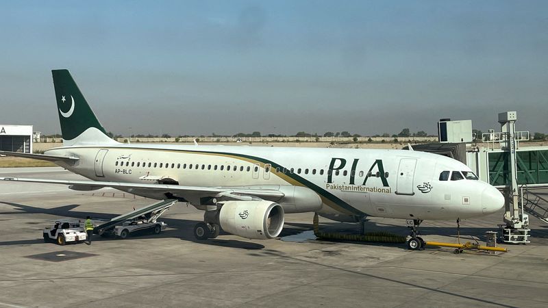 FILE PHOTO: View of a Pakistan International Airlines (PIA) passenger plane, taken through a glass panel, at Islamabad International Airport, Pakistan October 3, 2023. REUTERS/Akhtar Soomro/File Photo