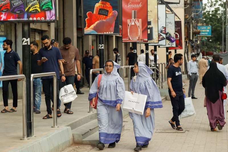 People walk outside shopping mall in Karachi, Pakistan September 23, 2025. REUTERS/Akhtar Soomro