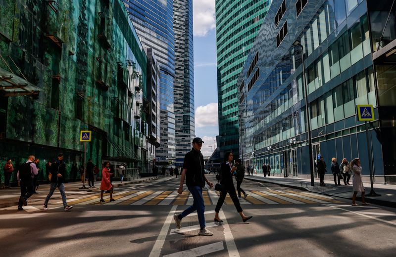 People walk in the Moscow International Business Center, also known as "Moskva-City" on a sunny day in Moscow, Russia May 25, 2022. REUTERS/Maxim Shemetov