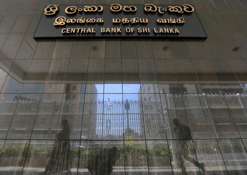People walk past the main entrance of the Sri Lanka's Central Bank in Colombo, Sri Lanka March 24, 2017. REUTERS/Dinuka Liyanawatte