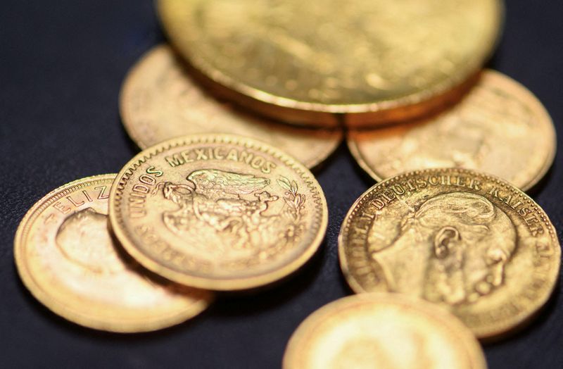 FILE PHOTO: Gold coins are pictured at the local shop of goldsmith Axel Harbaum-Neuhaus in Bonn, Germany, October 21, 2025, as gold prices rise and many trade in their golden possessions. REUTERS/Jana Rodenbusch/File Photo