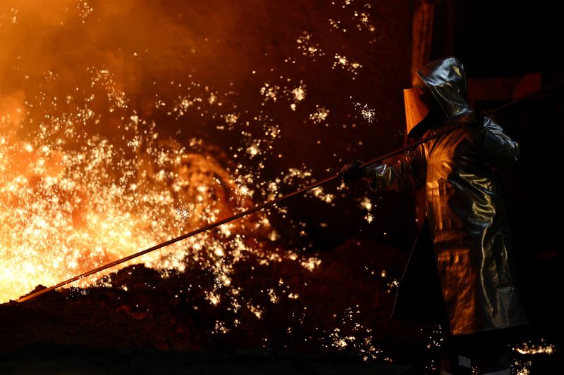A steel worker stands amid sparks of raw iron coming from a blast furnace at a ThyssenKrupp steel factory in Duisburg, Germany, November 5, 2025. REUTERS/Leon Kuegeler