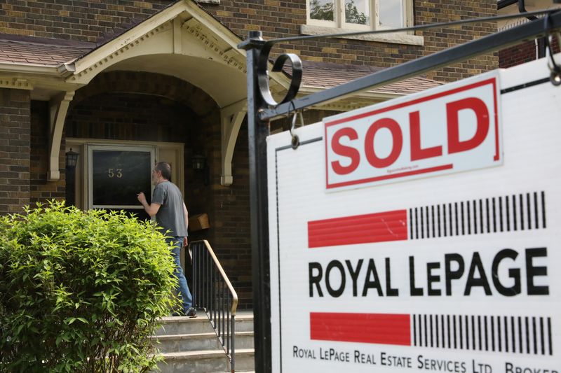 A realtor's for sale sign stands outside a house that had been sold in Toronto, Ontario, Canada May 20, 2021.  REUTERS/Chris Helgren