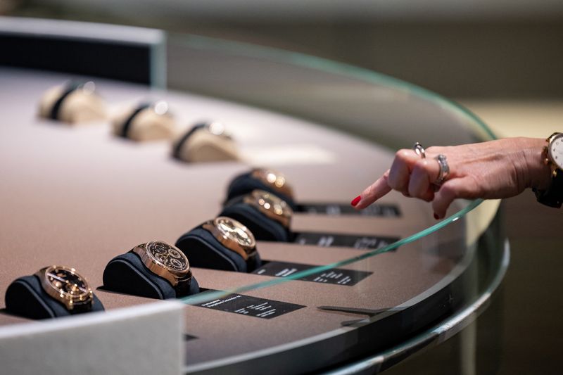 A visitor looks at watch models at the IWC Schaffhausen booth at the Watches and Wonders exhibition in Geneva, Switzerland, April 9, 2024. REUTERS/Pierre Albouy
