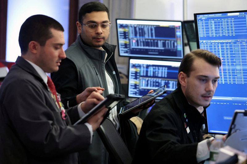 FILE PHOTO: Traders work on the floor at the New York Stock Exchange (NYSE) in New York City, U.S., February 23, 2026.  REUTERS/Brendan McDermid/File Photo