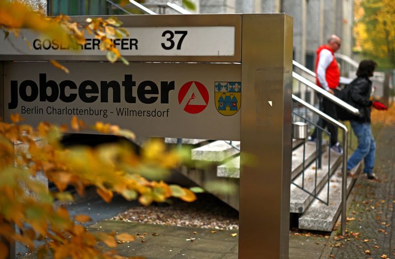 People walk outside a jobcenter in Berlin, Germany, October 14, 2025. REUTERS/Lisi Niesner