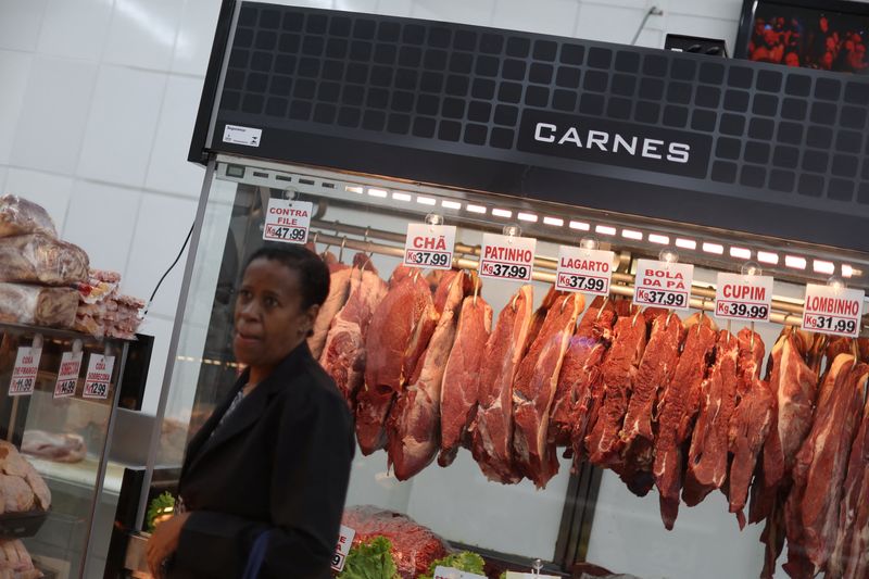 A client stands next to pieces of meat for sale at a butcher shop in Rio de Janeiro, Brazil July 31, 2025. REUTERS/Pilar Olivares