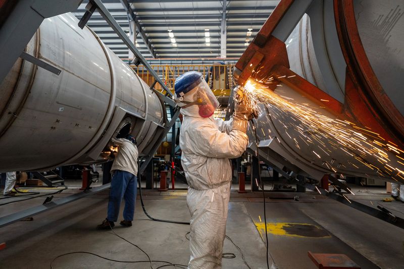 Workers work on a production line, manufacturing tank containers at a factory in Nantong, Jiangsu province, China April 7, 2025. cnsphoto via REUTERS