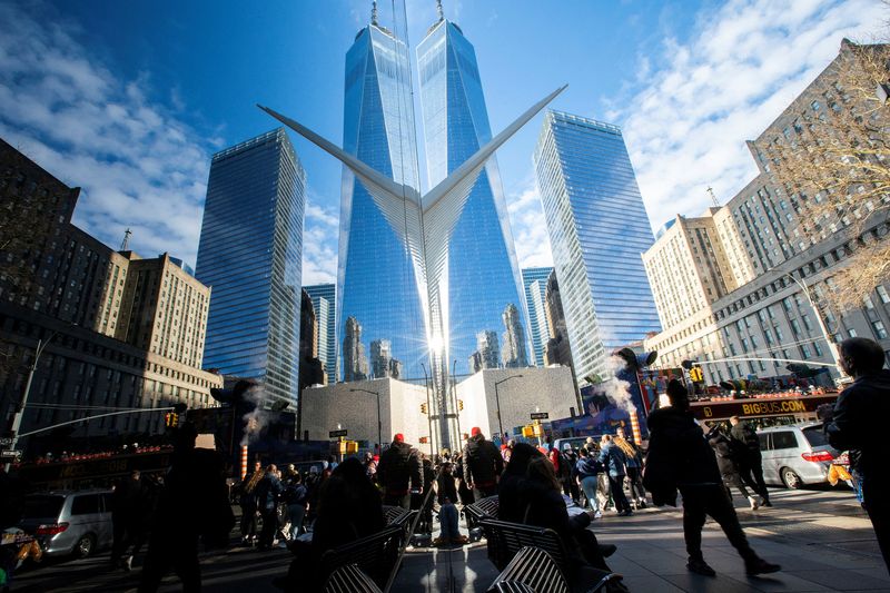 People walk around the Financial District near the New York Stock Exchange (NYSE) in New York, U.S., December 29, 2023. REUTERS/Eduardo Munoz