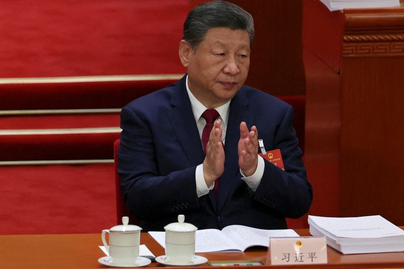 FILE PHOTO: Chinese President Xi Jinping applauds at the opening session of the National People's Congress (NPC) at the Great Hall of the People in Beijing, China March 5, 2026. REUTERS/Florence Lo/Pool/File Photo