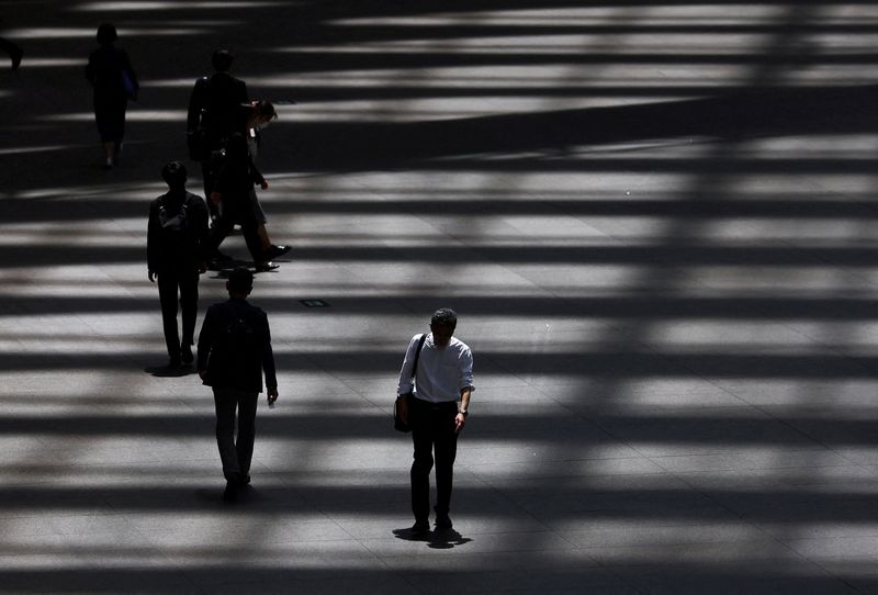 FILE PHOTO: People walk through a convention hall in Tokyo, Japan, May 15, 2025.  REUTERS/Issei Kato/File Photo