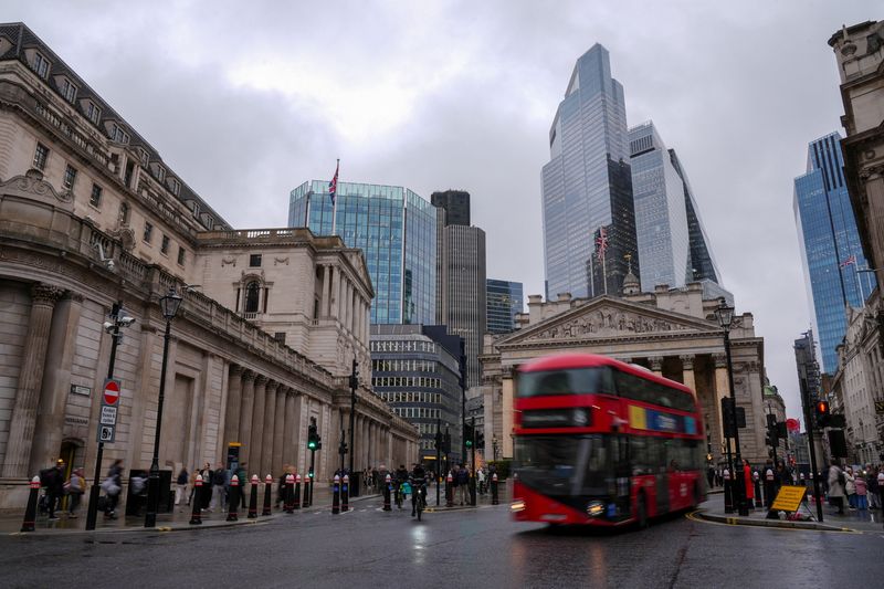 People walk near the Bank of England building in London, Britain, December 1, 2025. REUTERS/Maja Smiejkowska
