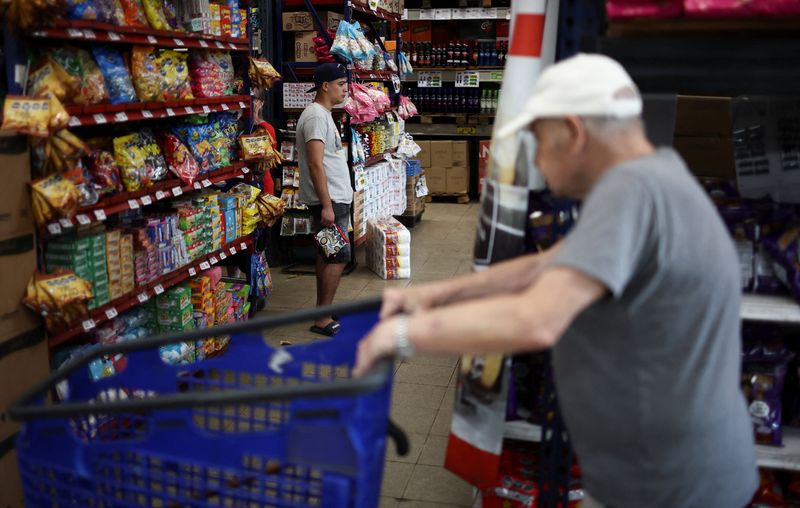 A shopper lines up at a supermarket checkout counter in Villa Martelli on the outskirts of Buenos Aires, Argentina, January 13, 2026. REUTERS/Agustin Marcarian