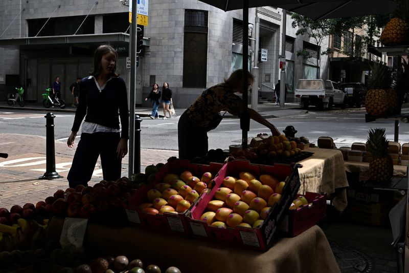 FILE PHOTO: A woman selects fruits at a street market stall in Sydney’s central business district, Australia, February 3, 2026. REUTERS/Flavio Brancaleone/File Photo