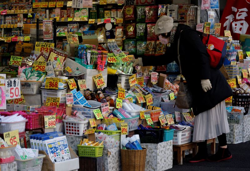 A woman chooses products at a drug store in Tokyo, Japan January 10, 2023. REUTERS/Issei Kato