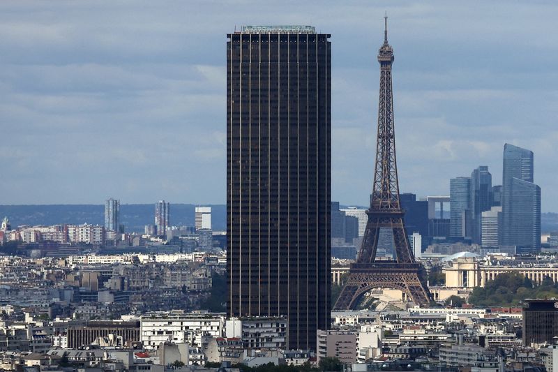 A general view shows the Montparnasse Tower and the Eiffel Tower with the financial and business district of La Defense in the background, in Paris, France, August 22, 2025. REUTERS/Abdul Saboor