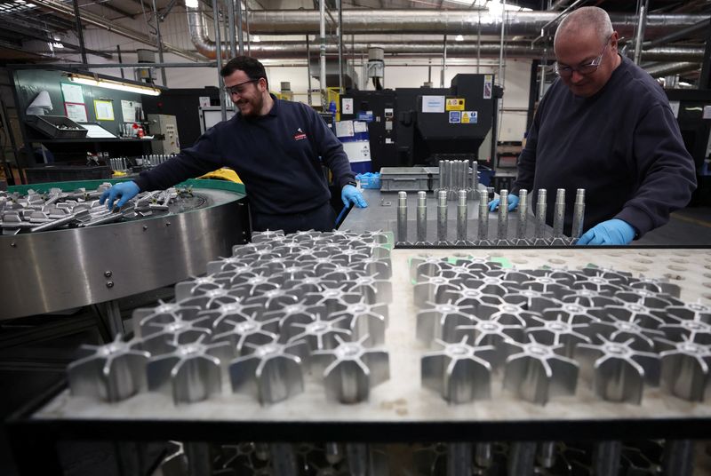 FILE PHOTO: A worker inspects a tail section from an 81mm Mortar round on the production line at the BAE munitions factory in Washington, Britain, November 8, 2023. REUTERS/Phil Noble/File Photo