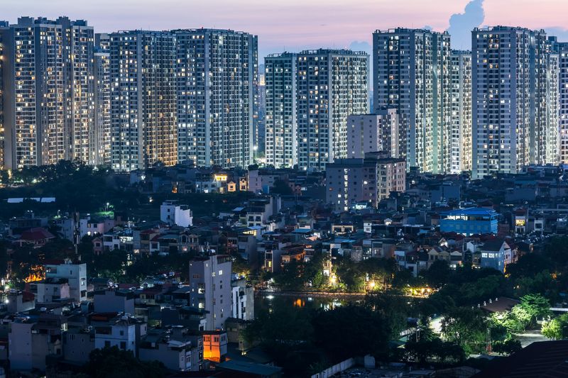 Lights illuminate condominium buildings and traditional houses in Hanoi, Vietnam, September 2, 2025. REUTERS/Athit Perawongmetha