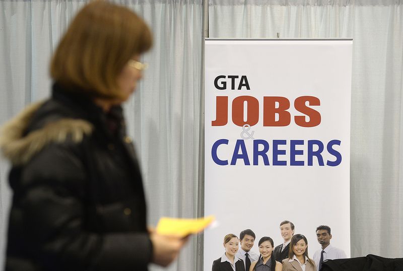 A woman walks through the 2014 Spring National Job Fair and Training Expo in Toronto, April 3, 2014. REUTERS/Aaron Harris/File Photo