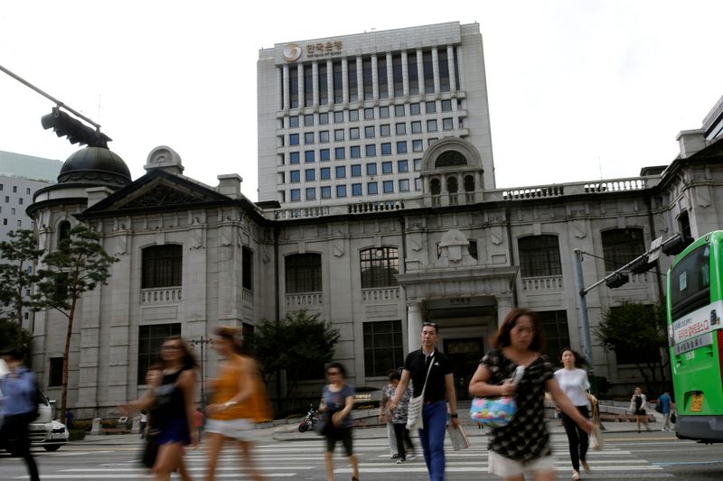 FILE PHOTO: People walk on a zebra crossing in front of the buliding of Bank of Korea in Seoul, South Korea, July 14, 2016.  REUTERS/Kim Hong-Ji/File Photo