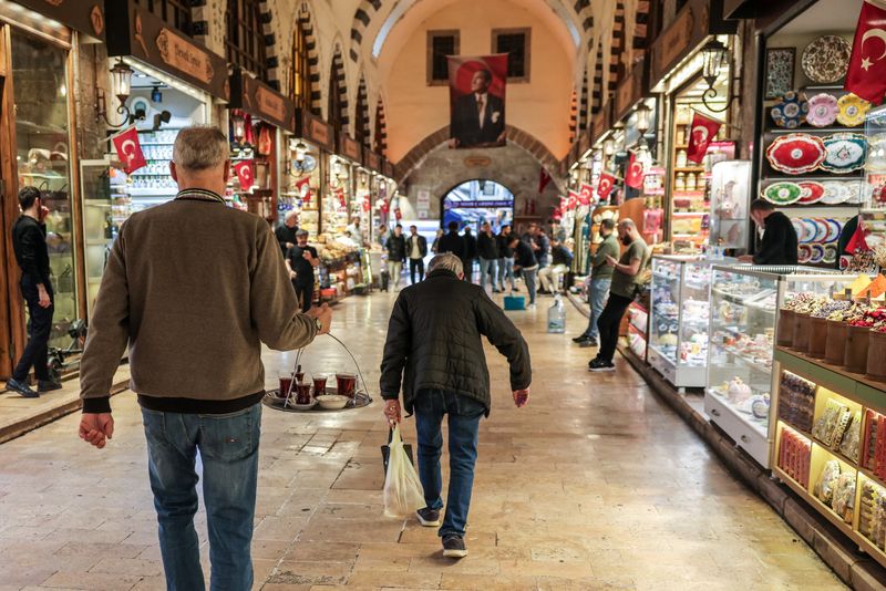 A man carries tea for sale at a spice market in Istanbul, Turkey, April 3,2025. REUTERS/Louisa Gouliamaki
