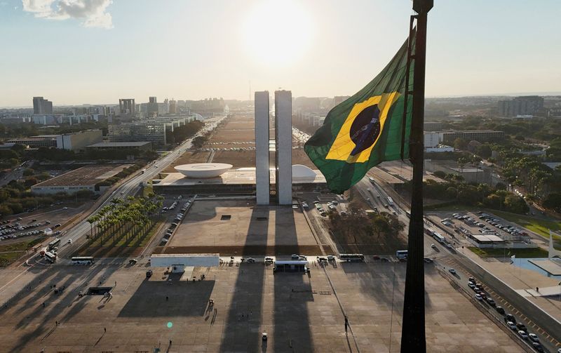 A drone view shows a Brazilian flag fluttering near the Square of the Three Powers and the National Congress, in Brasilia, Brazil August 1, 2025. REUTERS/Adriano Machado