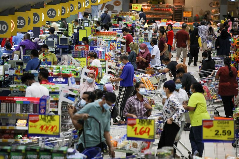 People line up to pay at a supermarket in Subang Jaya, Malaysia October 12, 2020. REUTERS/Lim Huey Teng