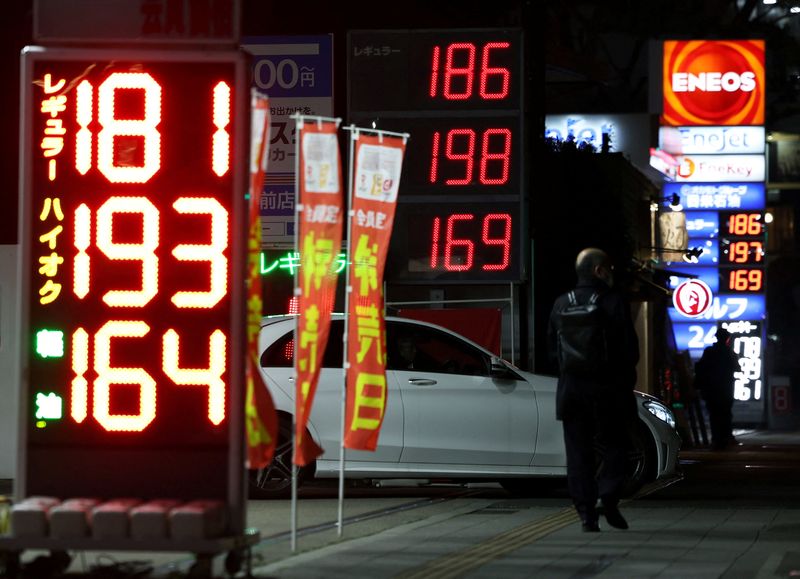 Signboards display fuel prices outside gas stations, amid the U.S.-Israel conflict with Iran, in Tokyo, Japan, March 13, 2026. REUTERS/Issei Kato