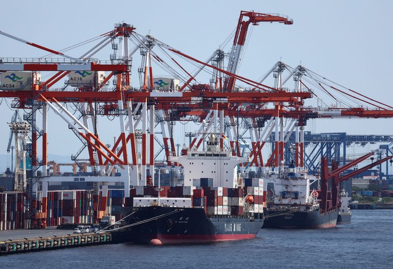 A cargo ship carrying containers is seen at an industrial port within Tokyo Port, Japan August 28, 2025. REUTERS/Issei Kato