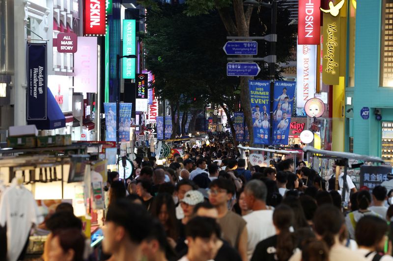 People walk at Myeongdong shopping district in Seoul, South Korea, August 5, 2025.   REUTERS/Kim Hong-Ji