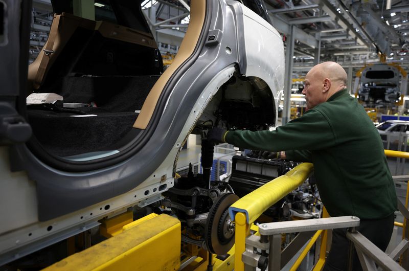A member of staff works on the production line at Jaguar Land Rover’s factory in Solihull, Britain, December 15, 2022. REUTERS/Phil Noble
