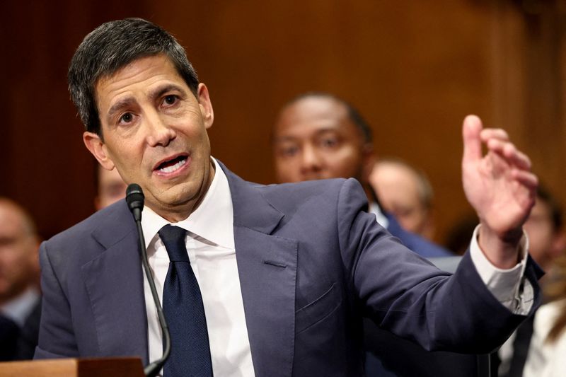 FILE PHOTO: Kevin Warsh, U.S. President Donald Trump's nominee to be next chair of the Federal Reserve, testifies before a Senate Banking Committee confirmation hearing on Capitol Hill in Washington, D.C., U.S., April 21, 2026. REUTERS/Kevin Lamarque/File Photo