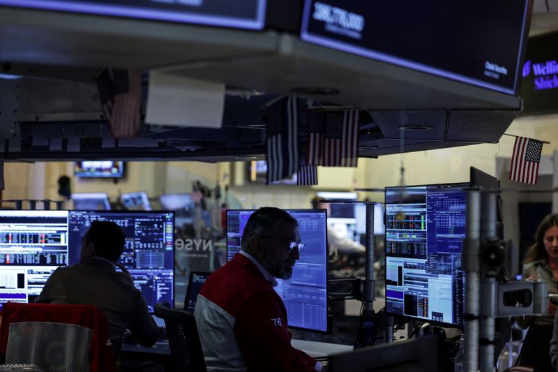 Traders work on the floor at the New York Stock Exchange (NYSE) in New York City, U.S., April 23, 2026. REUTERS/Jeenah Moon