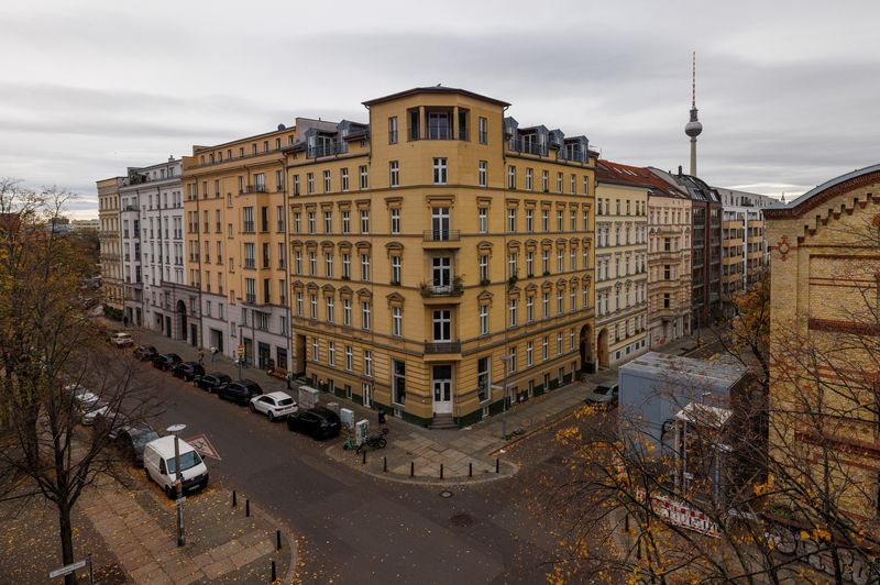Cars are parked next to residential houses with the TV tower in the background in the district of Prenzlauer Berg in Berlin, Germany, November 9, 2023. REUTERS/Lisi Niesner